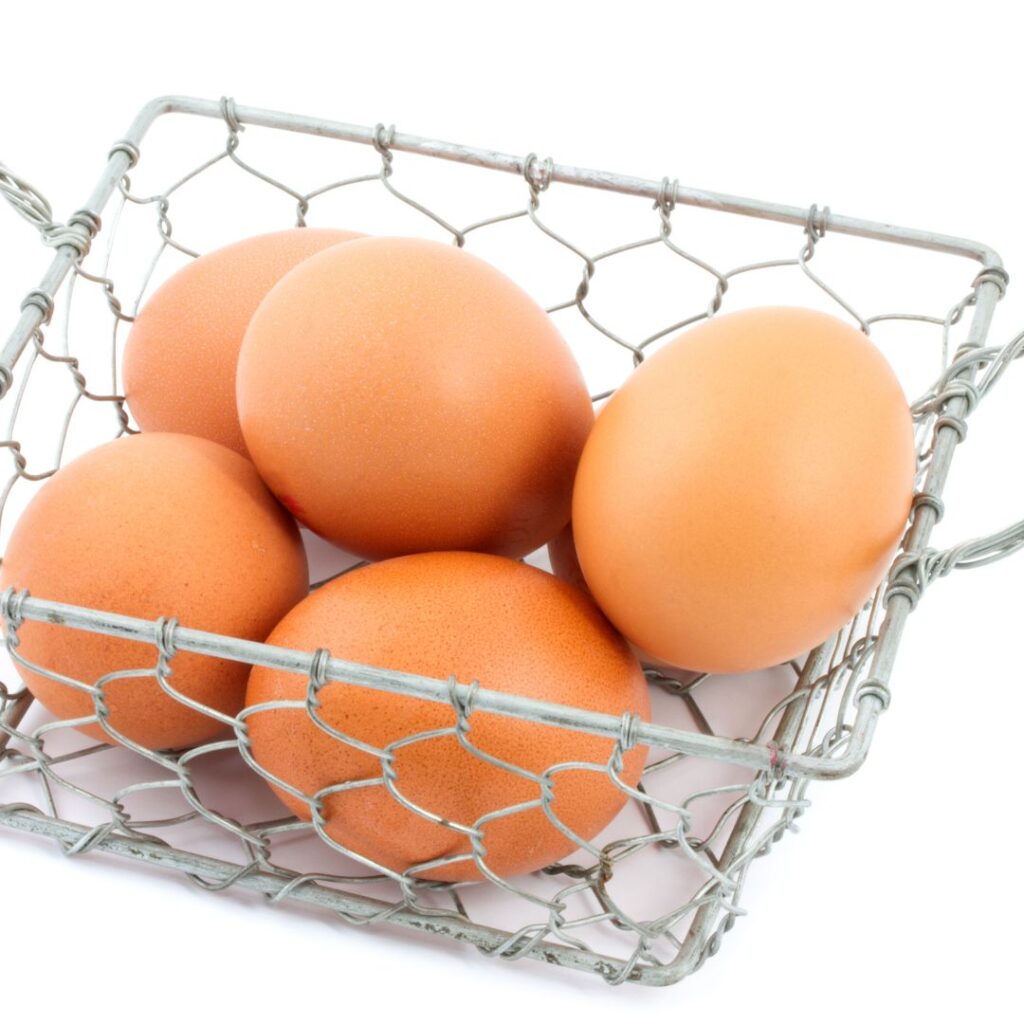 brown eggs in a chicken wire basket